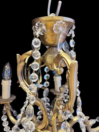 A  Pair of Six Light French Brass and Crystal Antique Chandeliers